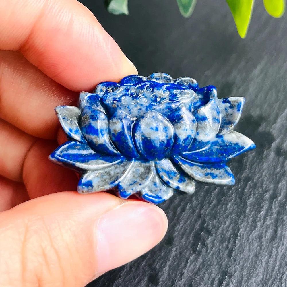 Hand holding a vibrant blue Lapis Lazuli lotus flower crystal sculpture, symbolizing peace and tranquility.