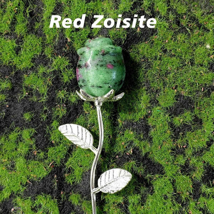 Red Zoisite crystal carved rose flower with detailed petals on a silver stem, perfect for healing and altar decor.
