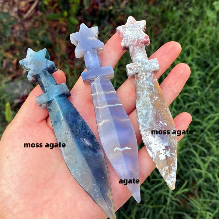 Hand-carved moss agate and agate crystal sword letter openers with star hilts, perfect for energy work.