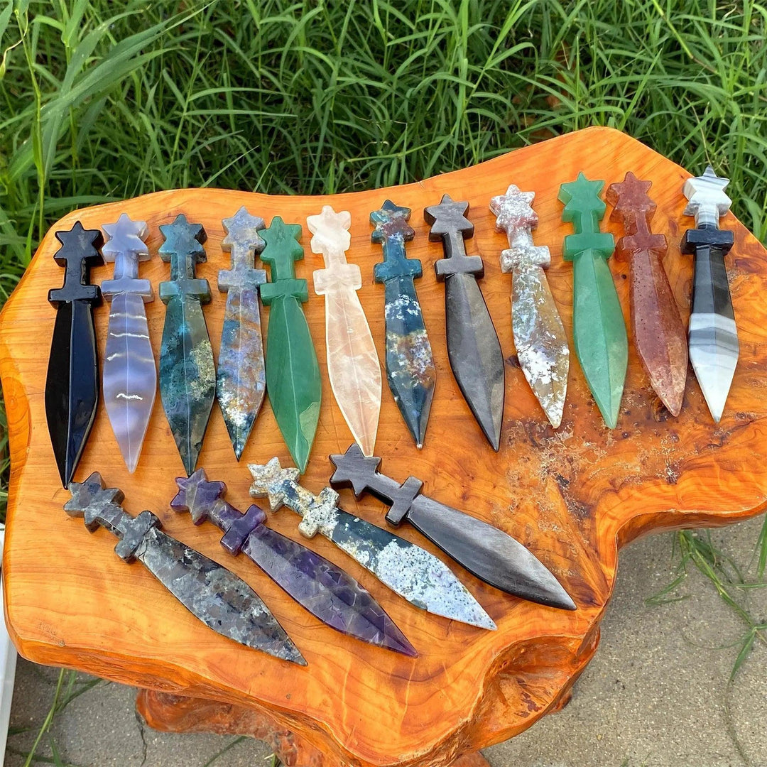 Assorted crystal carved sword letter openers, multi-stone specimens for manifestation, protection, and ritual work.