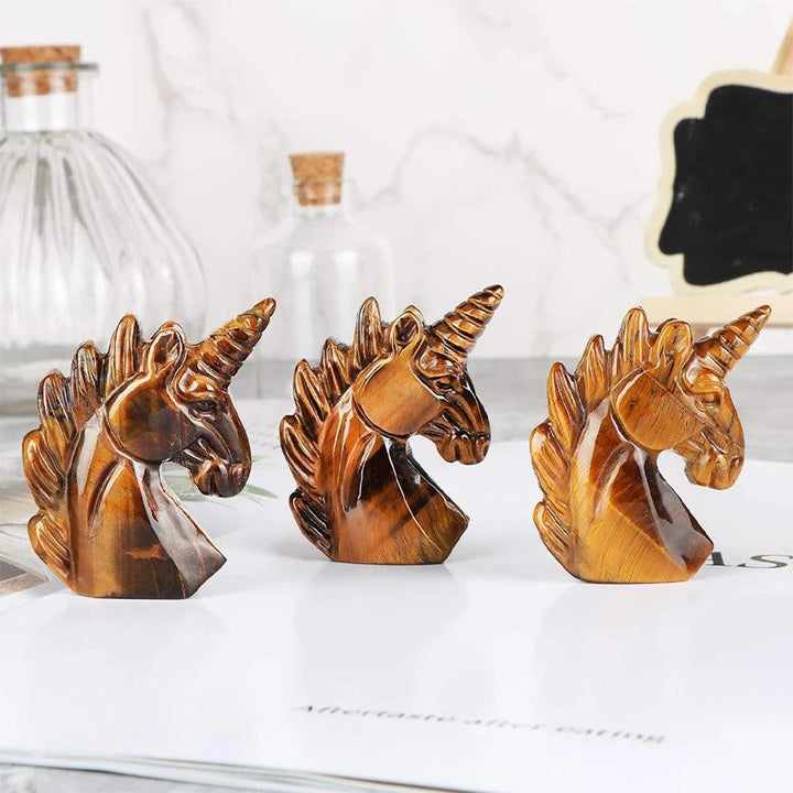 Three 51mm hand-carved Tiger’s Eye crystal unicorn figurines with golden-brown luster for Solar Plexus energy.