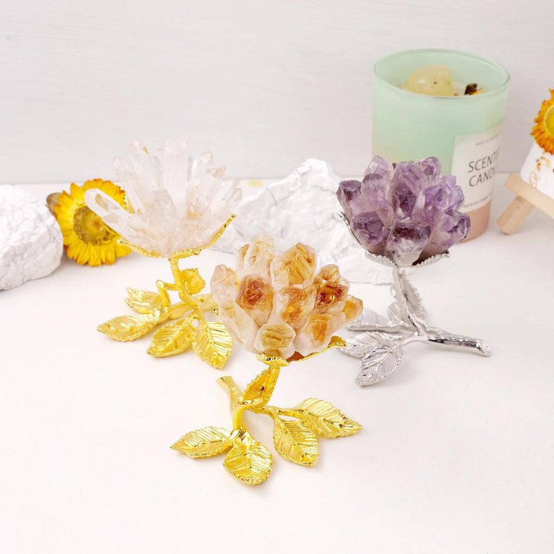 Three raw crystal cluster flower trees: clear quartz, citrine, and amethyst, on gold and silver leaf bases.