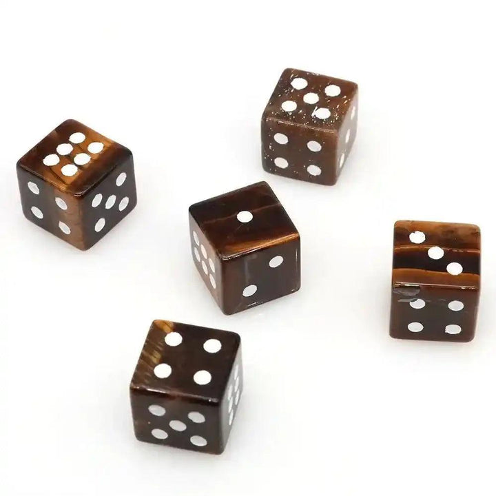 Five hand-carved Tiger Eye Crystal Dice with gold pips, showcasing chatoyant gold and brown hues.