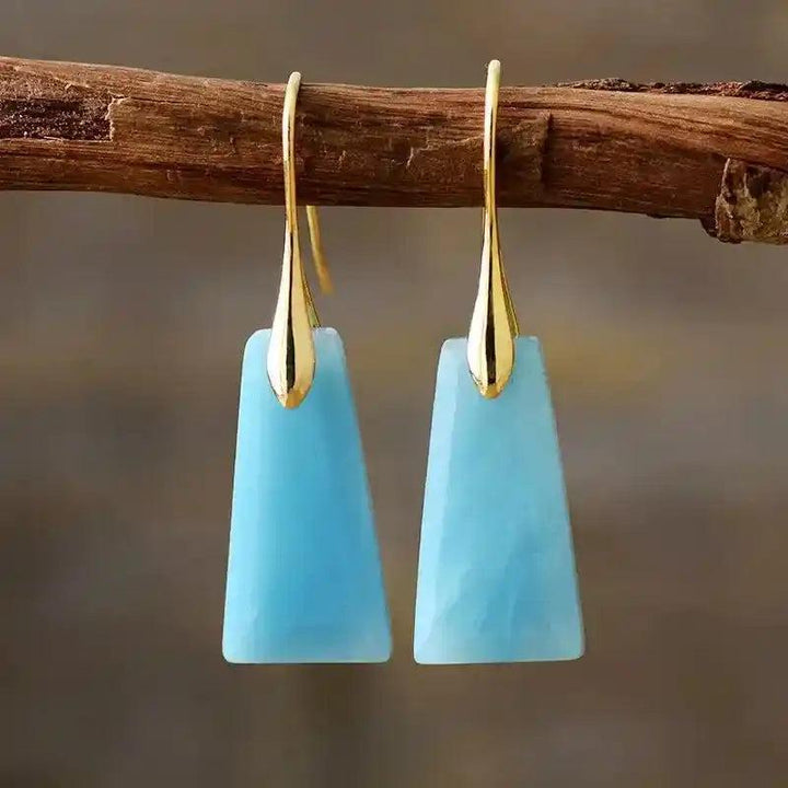 Natural blue chalcedony geometric dangle earrings with gold hooks, offering clarity and style.