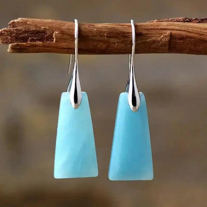 Light blue natural gemstone geometric dangle earrings for clarity and protection, featuring sleek silver hooks.