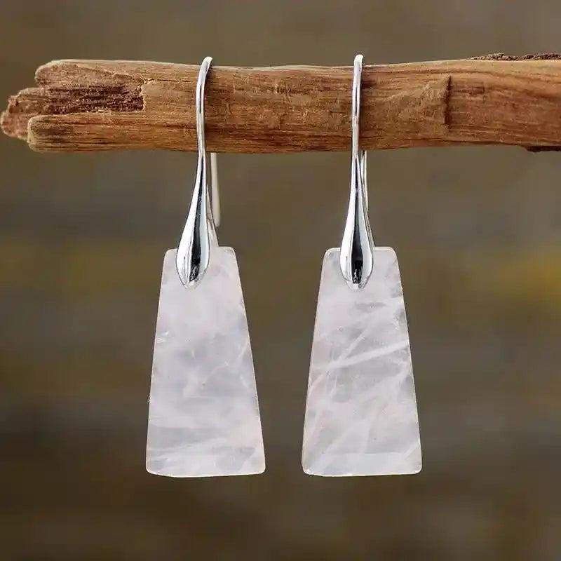 Rose Quartz Geometric Dangle Earrings. Sleek silver hooks hold rectangular, translucent pink gemstones for love and clarity.