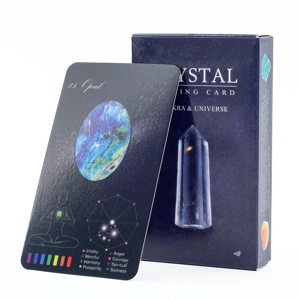Crystal Healing Oracle Cards: Black "Opal" card with cosmic art, chakra guide, and dark blue box.