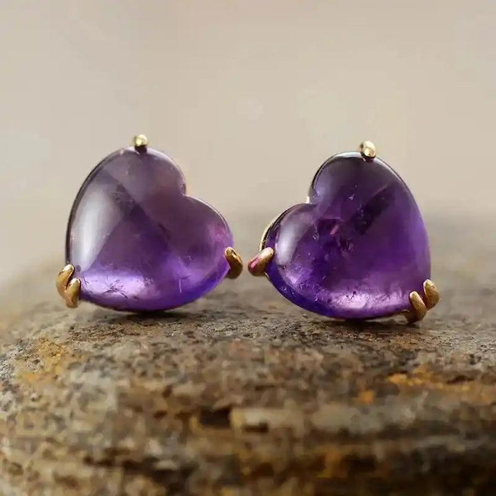 Radiant amethyst heart-shaped gemstone stud earrings, promoting calm and spiritual growth.