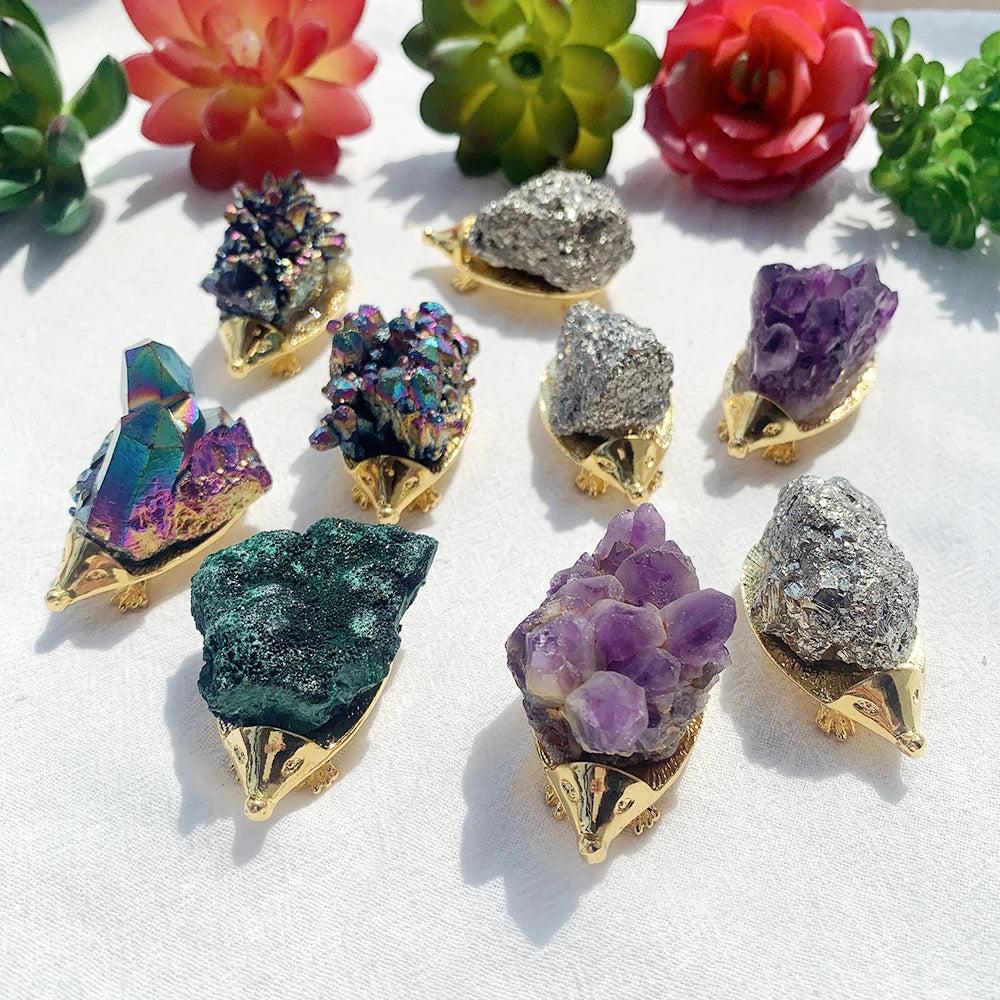 Assorted Crystal Hedgehog Figurines: vibrant amethyst, iridescent rainbow cluster, and sparkling chalcopyrite for healing and growth.