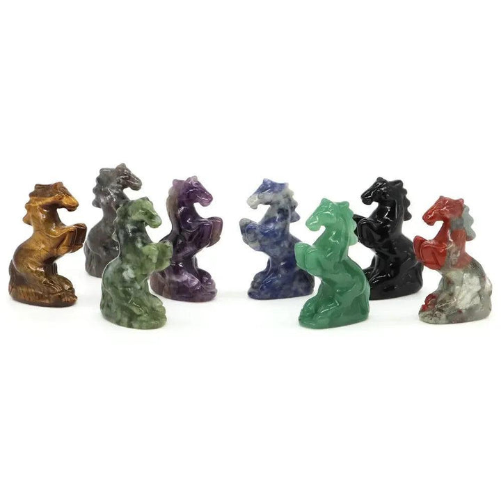 Assorted crystal horse carvings in various colors, including green aventurine, for luck and good fortune.