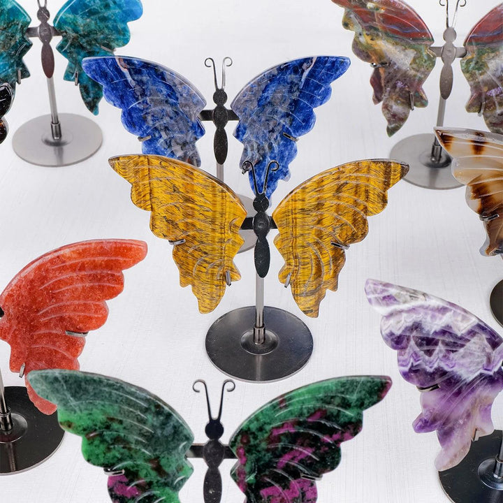 Polished crystal butterfly wings in various stones like yellow Tiger Eye, blue Sodalite, red Agate, and green Epidote.