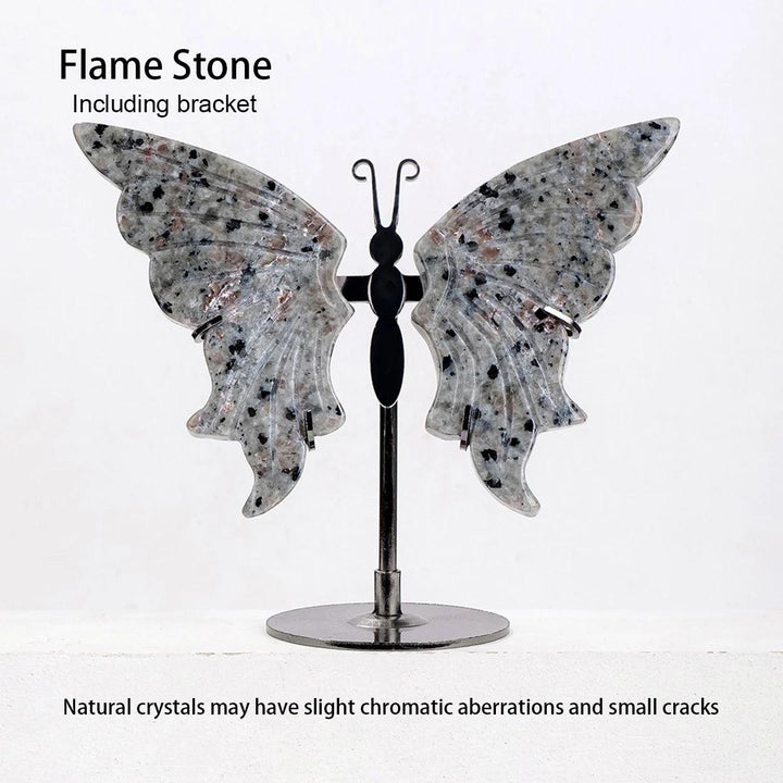 Polished Flame Stone crystal butterfly wings with black speckles, displayed on a sleek black metal stand.
