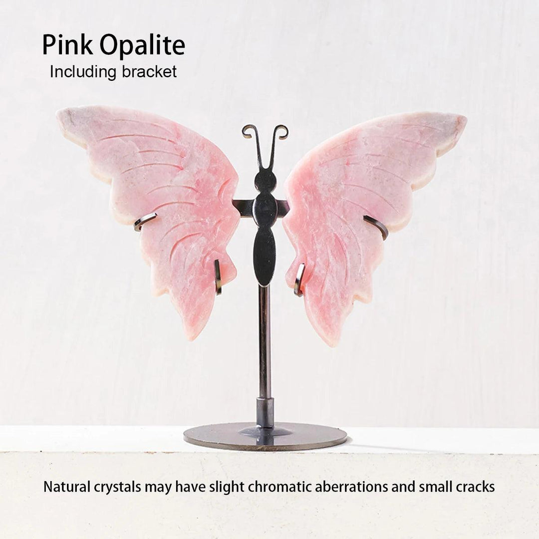 Polished pink Opalite crystal butterfly wings on a black metal stand, symbolizing growth and new beginnings.