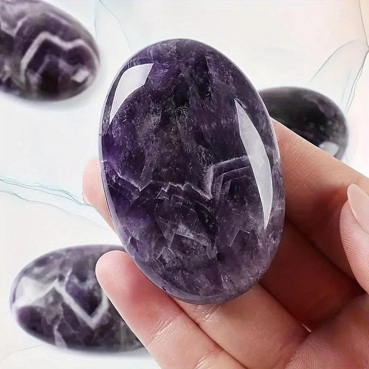 Polished amethyst natural crystal palm stone for stress relief and healing energy.