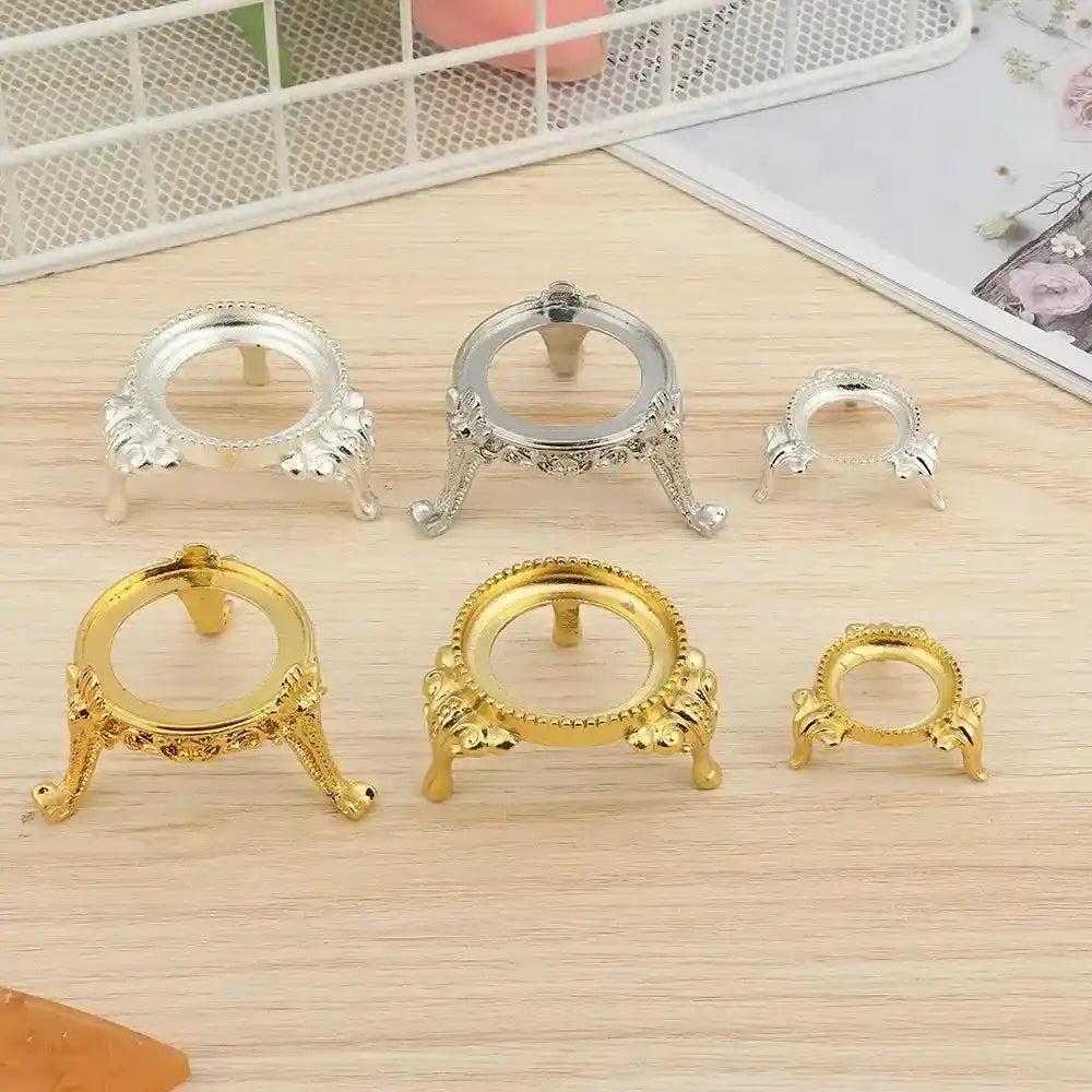 Assorted gold and silver ornate metal crystal sphere display stands in various sizes, perfect for elegant gemstone showcasing.