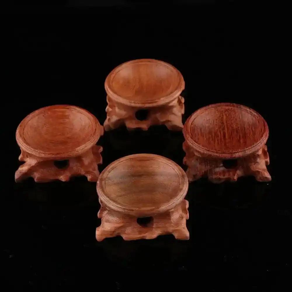Assorted natural wood crystal sphere display stands, showcasing elegant craftsmanship for gemstones and miniature stones.