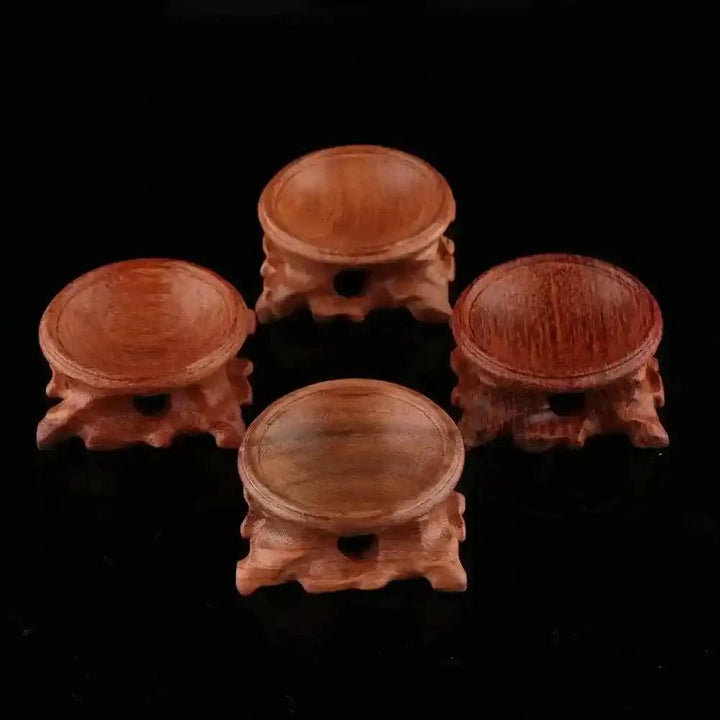 Assorted natural wood crystal sphere display stands, showcasing elegant craftsmanship for gemstones and miniature stones.