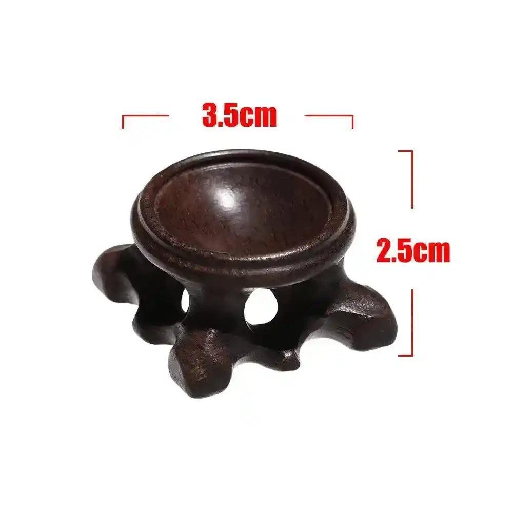 Dark brown wooden crystal sphere display stand, 3.5cm wide, 2.5cm tall, with a carved, elegant design.