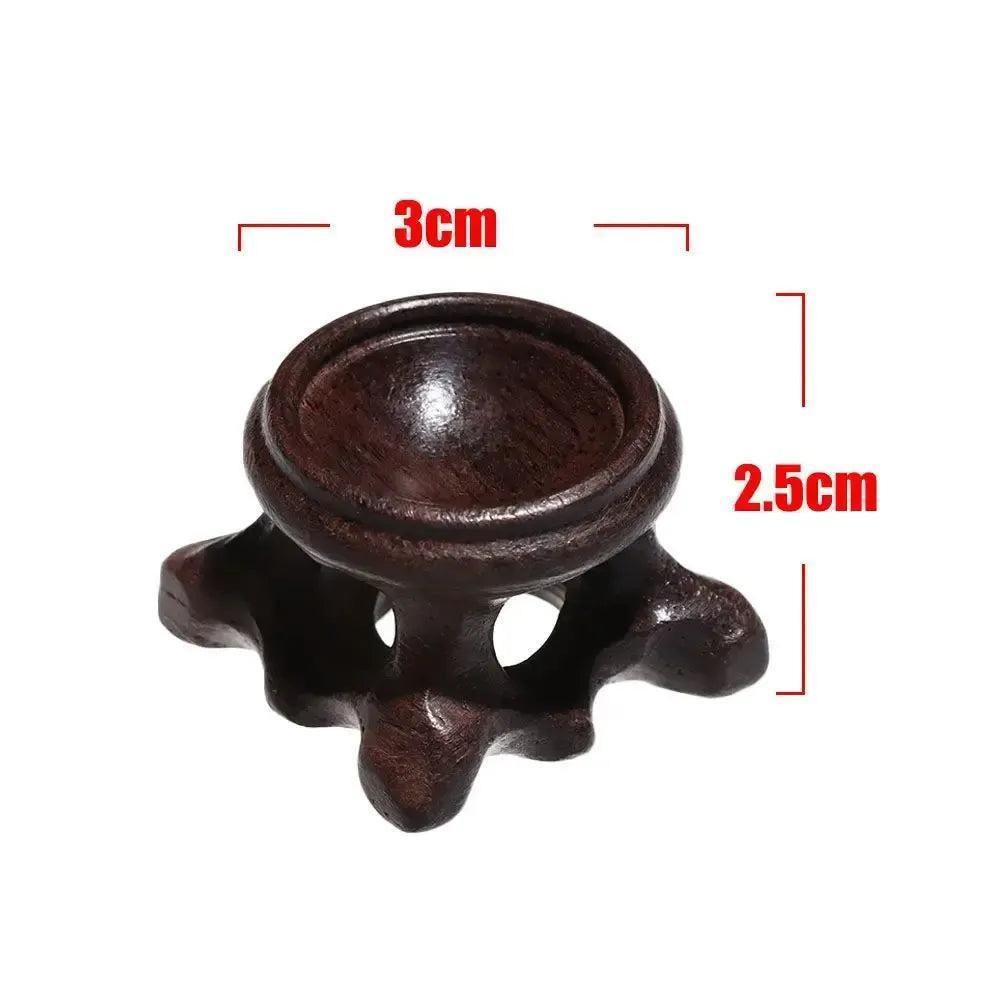 Elegant dark wood crystal sphere display stand, 3cm wide, 2.5cm tall, perfect for showcasing gemstones.