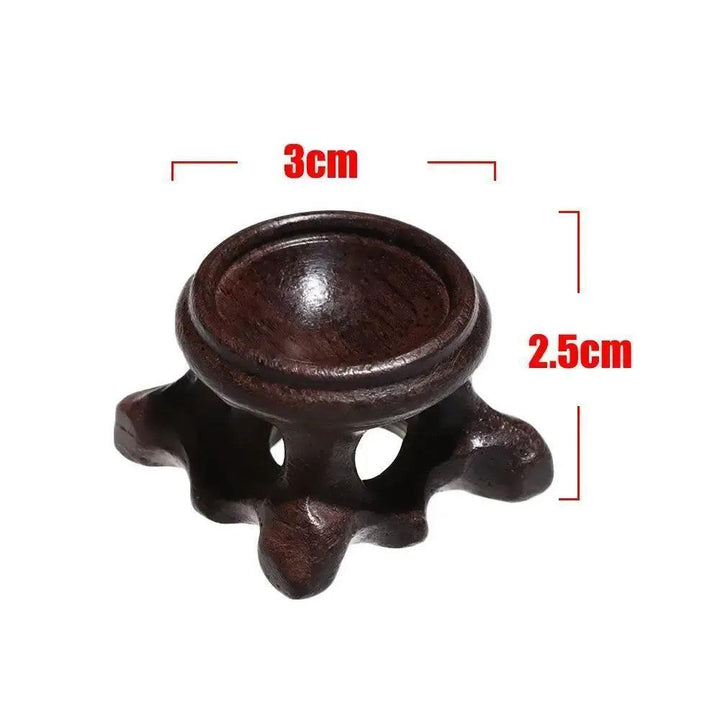 Elegant dark wood crystal sphere display stand, 3cm wide, 2.5cm tall, perfect for showcasing gemstones.