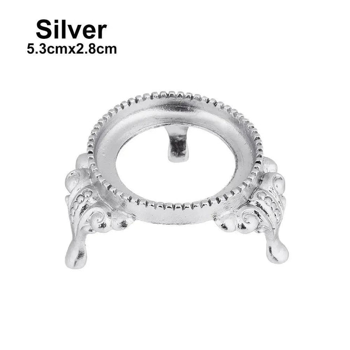 Elegant silver metal crystal sphere display stand, 5.3cmx2.8cm, with ornate legs and a decorative rim for gemstones.