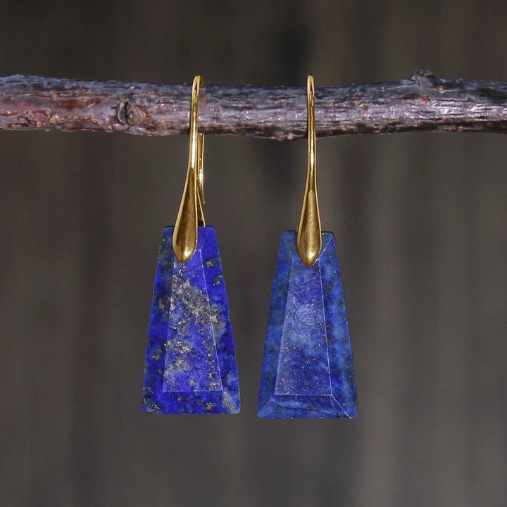 Lapis Lazuli Crystal Stone Faceted Drop Earrings. Deep blue trapezoidal stones with gold hooks for communication and truth.