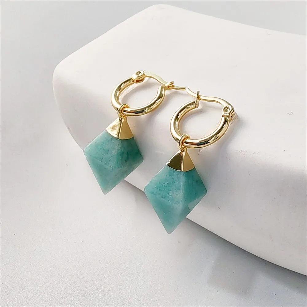 Gold hoop earrings with teal amazonite crystal stones, supporting the Heart Chakra for emotional balance.