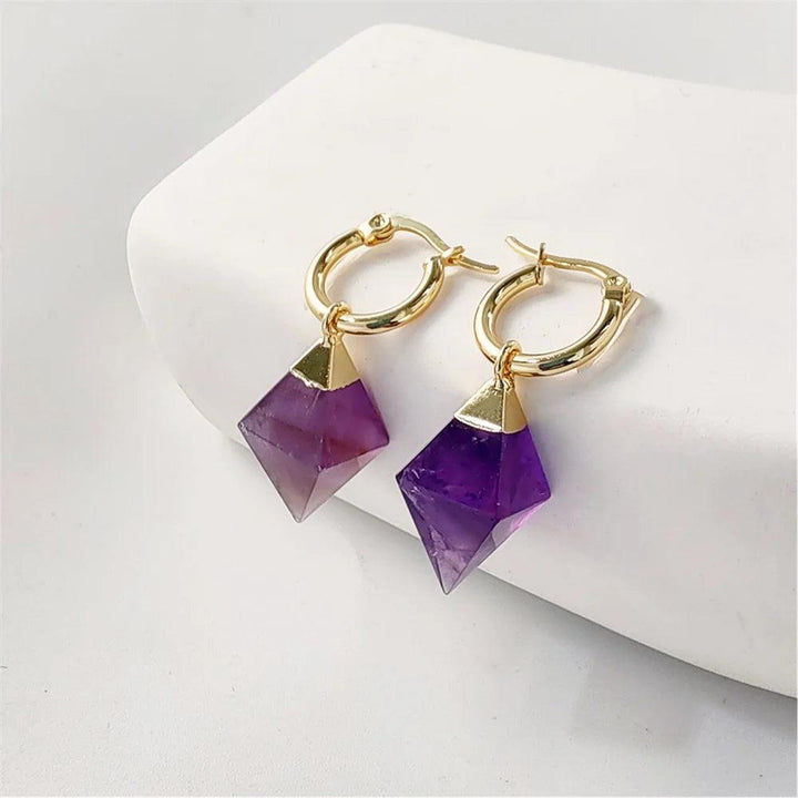 Gold hoop earrings with faceted amethyst crystal drops for spiritual clarity.