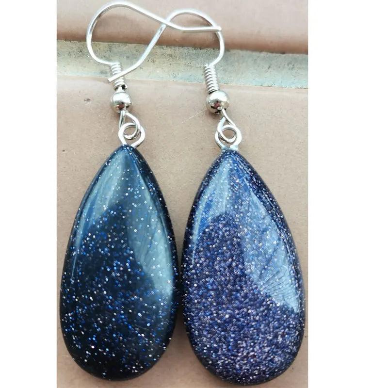 Blue sand teardrop drop earrings with sparkling blue goldstone, set in copper wire for grounding and stability.