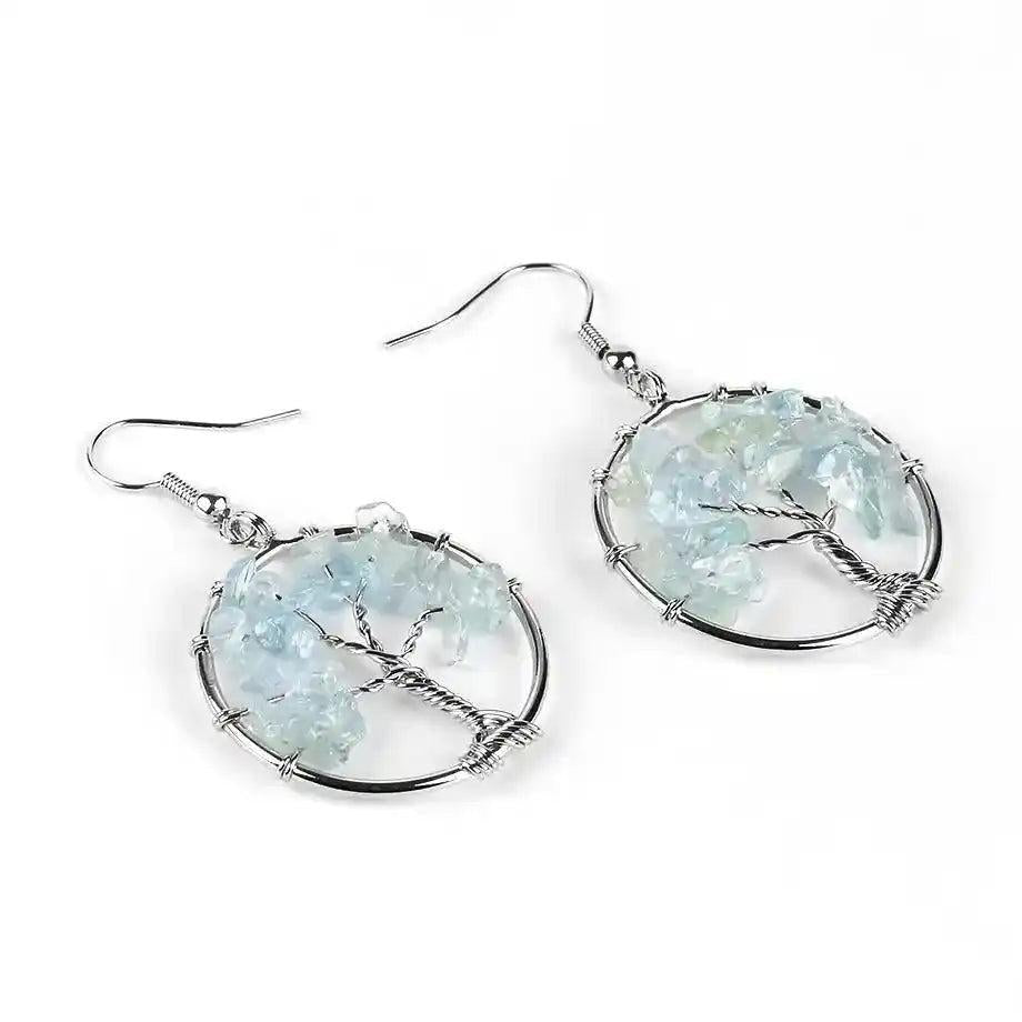 Tree of Life Crystal Drop Earrings with light blue gemstones, symbolizing growth and positive energy.