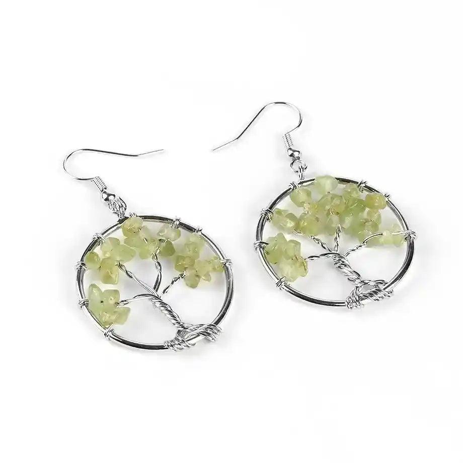 Tree of Life Crystal Drop Earrings with vibrant green peridot gemstones, symbolizing growth and positive energy.