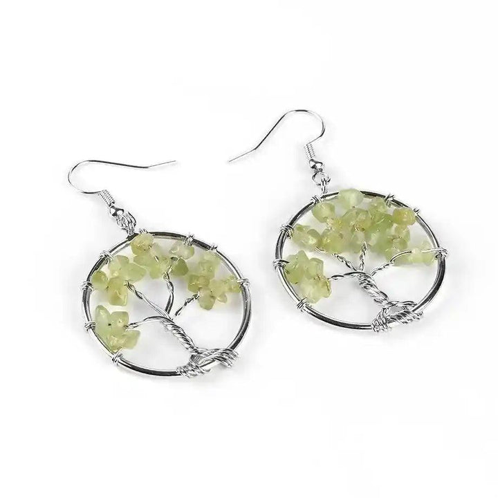 Tree of Life Crystal Drop Earrings with vibrant green peridot gemstones, symbolizing growth and positive energy.
