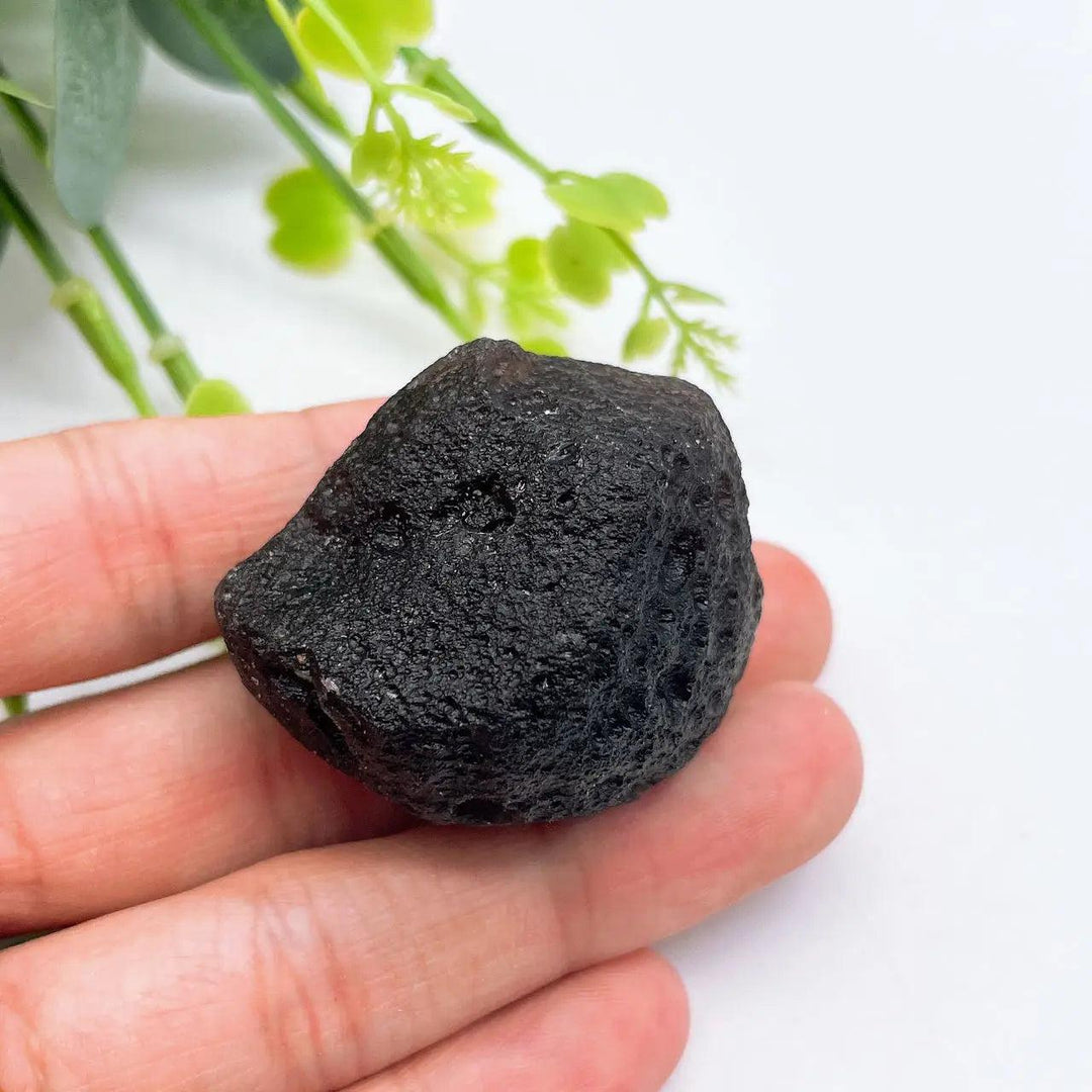 Raw, irregular Czech Black Tektite meteorite specimen, dense and dark, for grounding and protection.