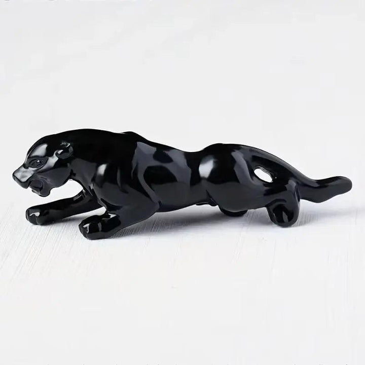 Hand-carved Obsidian crystal leopard figurine with a sleek, black protective finish for grounding and sacred spaces.