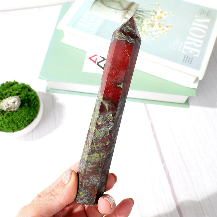 Natural dragon blood stone crystal wand obelisk, 15-17cm, with deep red and green patterns, held in hand.