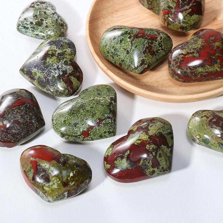 Polished green and red dragon bloodstone crystal heart worry stones for spiritual healing.