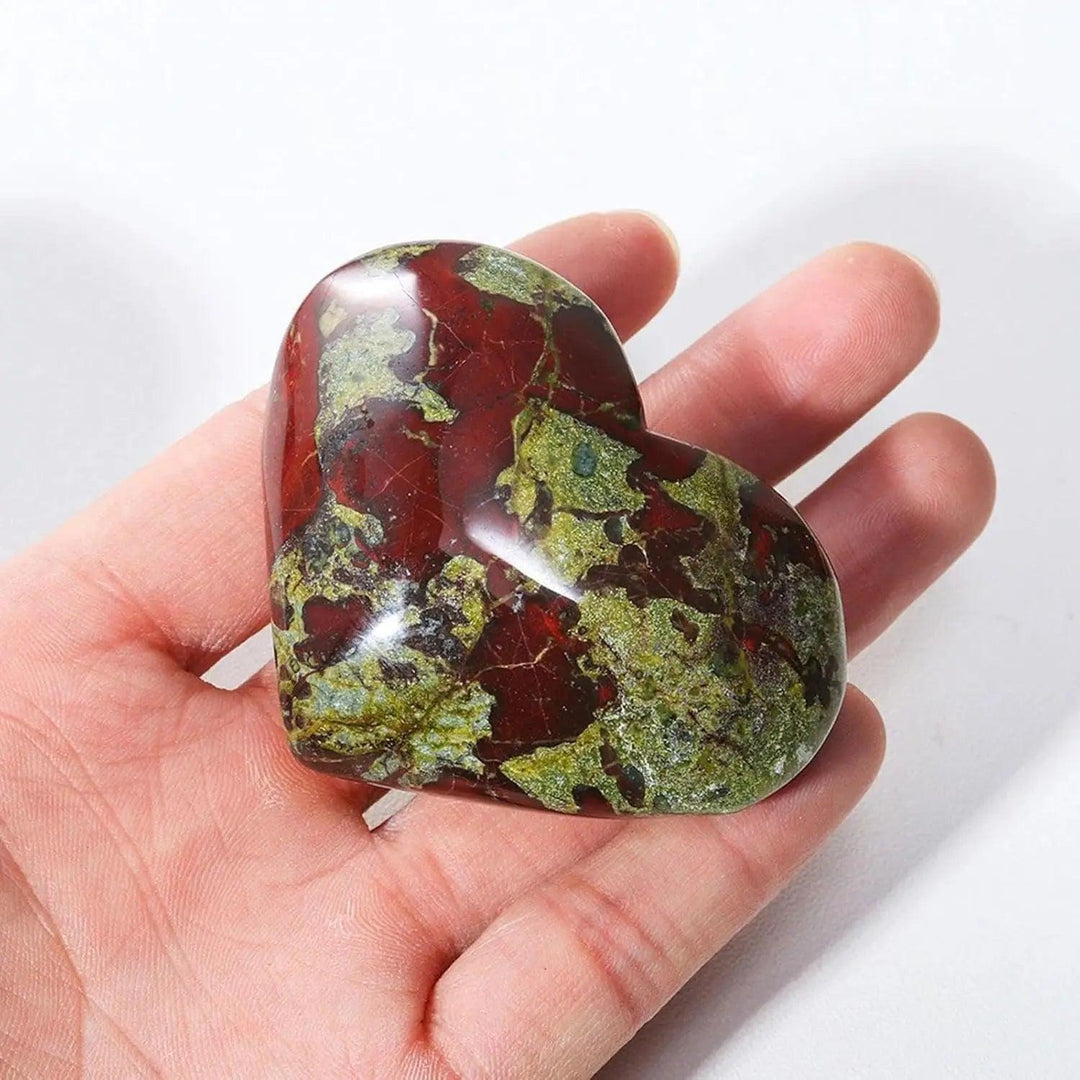 Polished red and green natural dragon bloodstone crystal heart worry stone for spiritual healing.