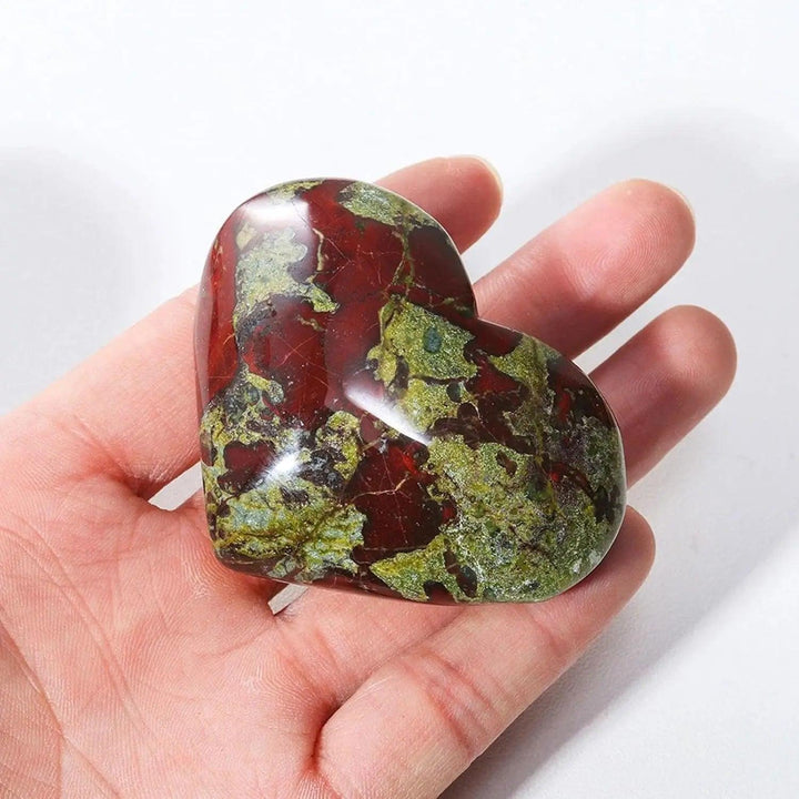 Polished red and green natural dragon bloodstone crystal heart worry stone for spiritual healing.