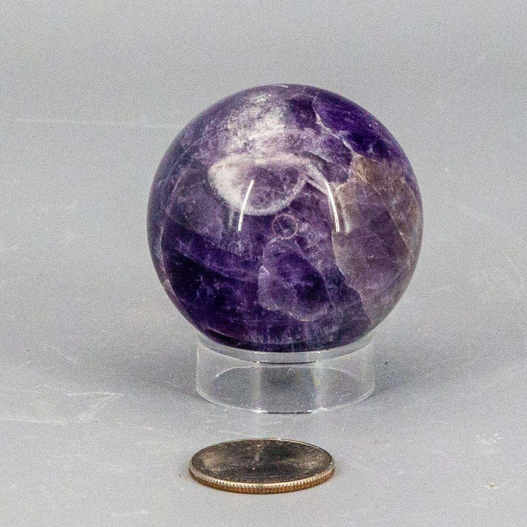 Dream Amethyst Sphere, 49mm, showcasing layered purple and white banding for a serene, unique appearance.