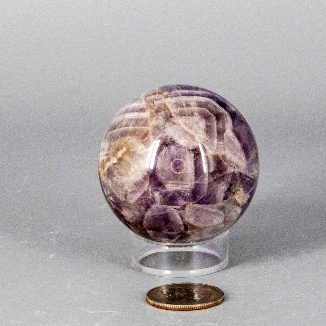 Dream Amethyst Sphere 51-57mm, featuring soft purple and white bands, radiating calming energy.
