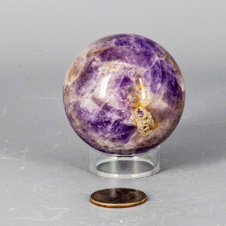 Dream Amethyst Sphere, 51-57mm, featuring soft purple and white bands, radiating calming energy for restful sleep.