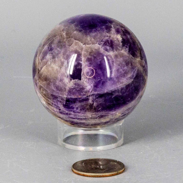 Dream Amethyst Sphere, 51-57mm, showcasing soft purple and white bands, ideal for meditation and restful sleep.