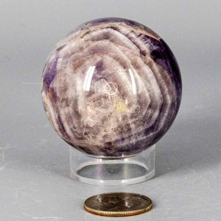 Dream Amethyst Sphere 51-57mm, featuring soft purple and white bands, radiating calming energy.
