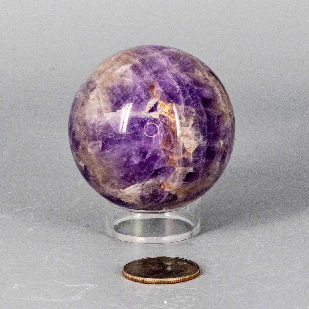Dream Amethyst Sphere (51-57mm) with flowing purple and white bands, radiating calming energy.