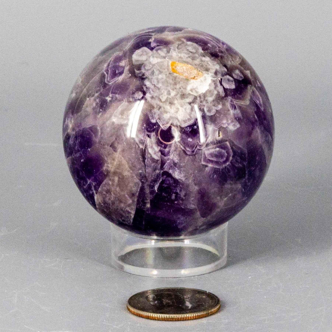 Dream Amethyst Sphere, 51-57mm, with flowing purple and white bands, radiating calming energy.