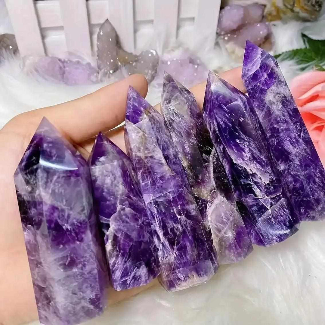 Hand-polished Dream Amethyst point towers featuring rich purple hues and faceted tips for meditation and energy healing.