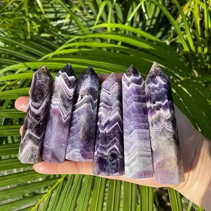 Hand-polished Dream Amethyst point towers featuring rich purple chevron patterns for meditation and spiritual calm.