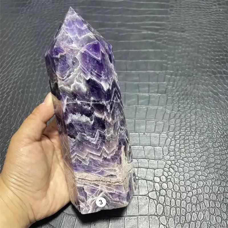 Polished Dream Amethyst tower with deep purple chevron patterns, faceted sides, and a pointed top for spiritual focus.
