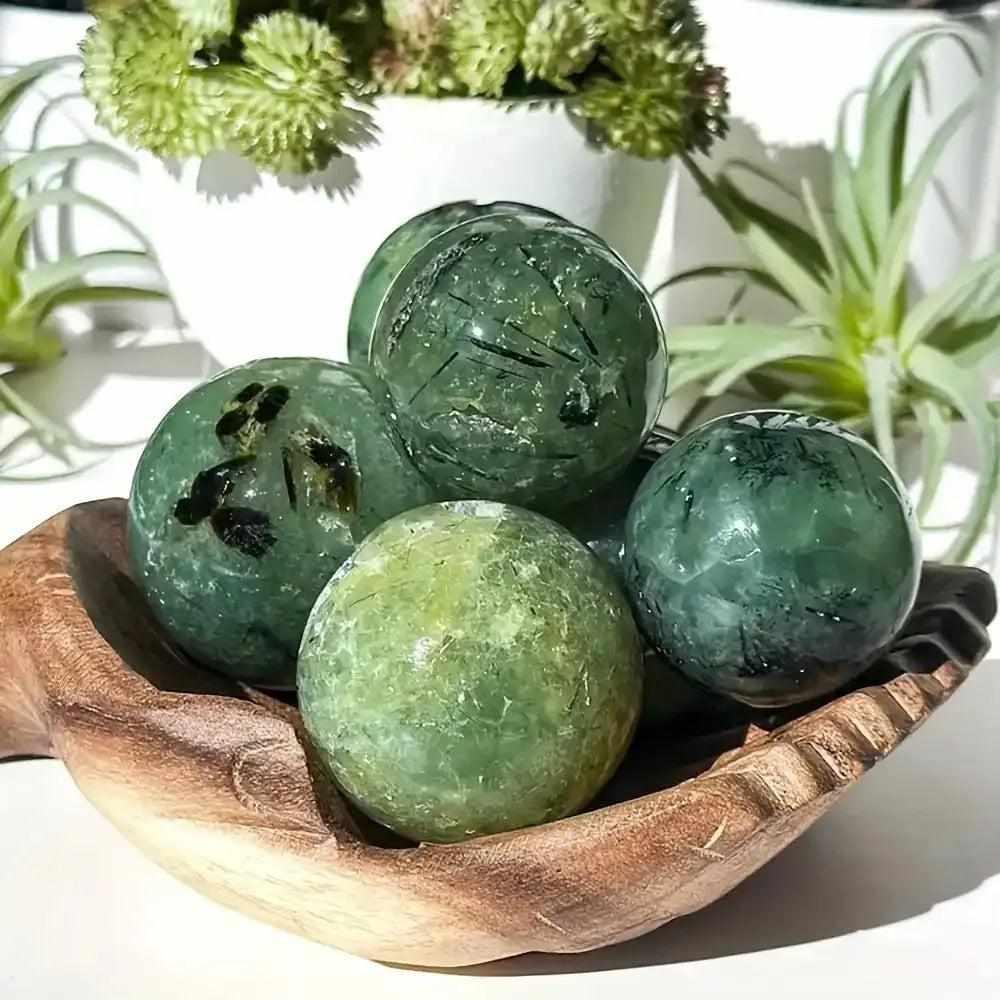 Polished apple green Druzy Prehnite spheres with dark Epidote inclusions, perfect for Heart Chakra balance and peace.
