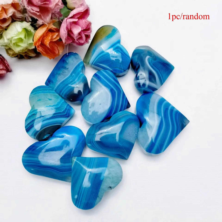 Polished blue agate heart palm stone with natural banding, perfect for Throat Chakra healing and calming meditation.